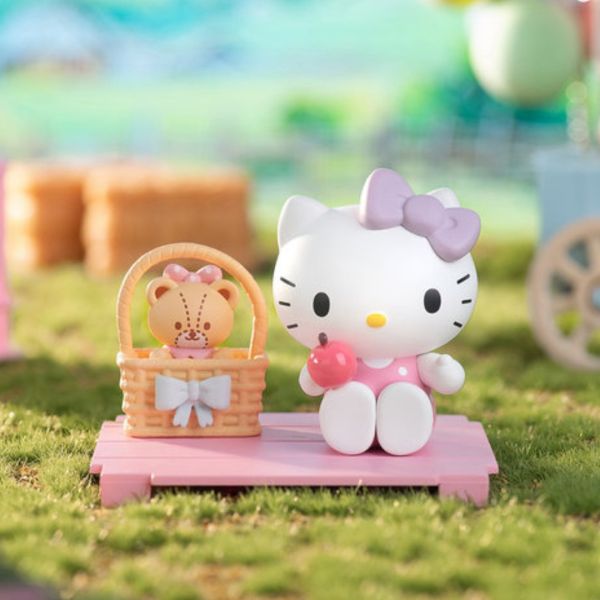 Hello Kitty in pink dress with a picnic basket, part of the Sanrio Sweetheart Companion collectibles.