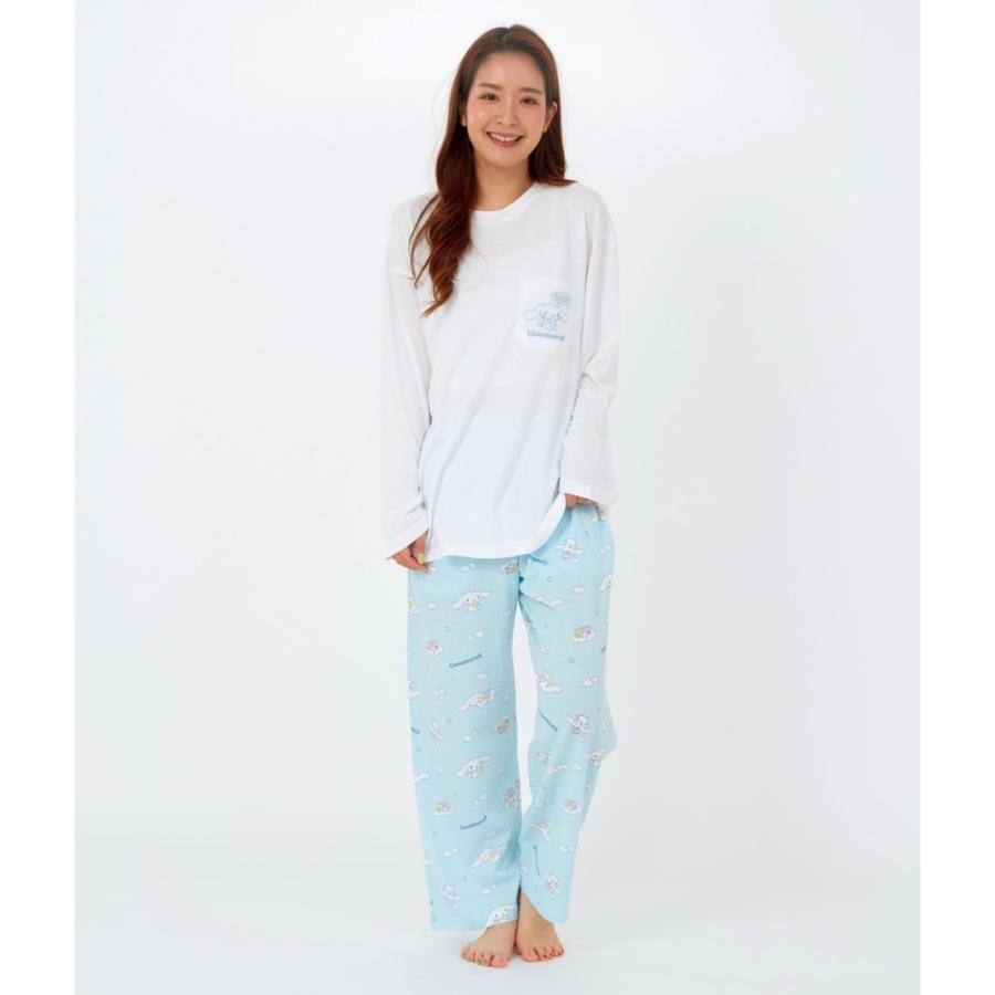 Front view of a model wearing a white Cinnamoroll long-sleeve pajama top with matching light blue printed pajama pants.