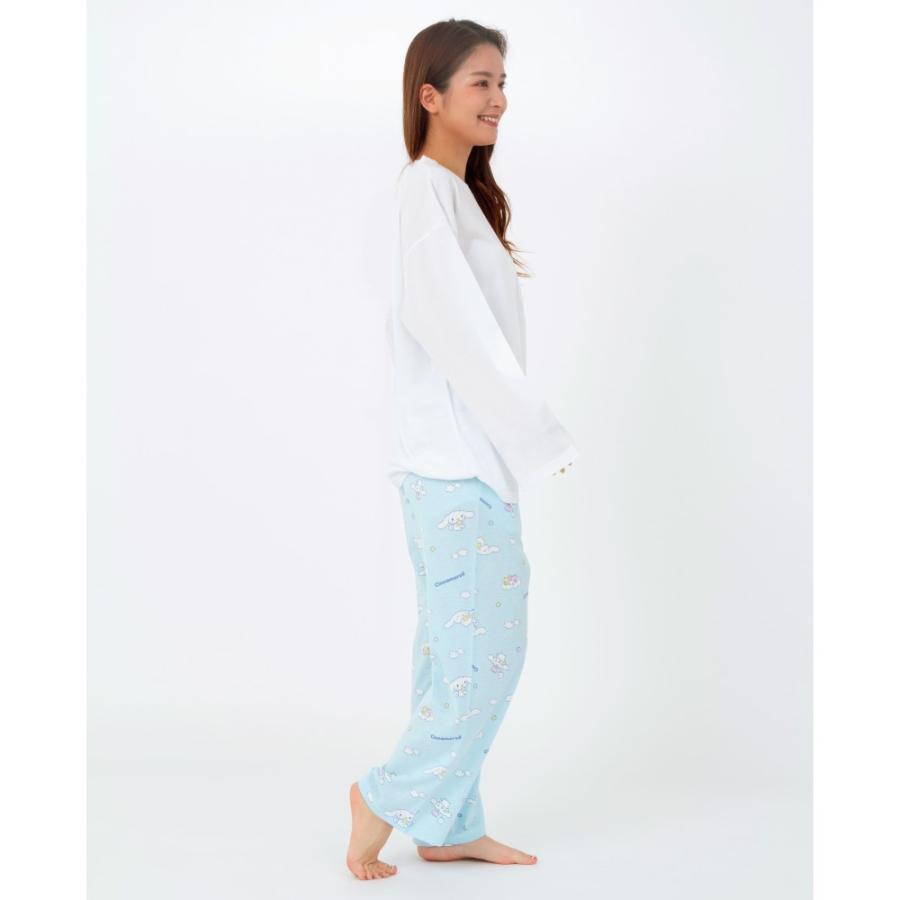Woman in Cinnamoroll pajamas standing relaxed with a side profile view, highlighting the casual and loose design.