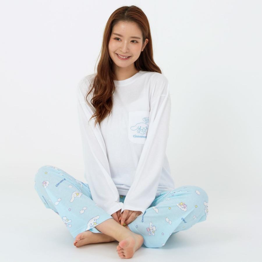 Model sitting casually in Cinnamoroll pajamas, with a focus on the light blue printed pants and white top