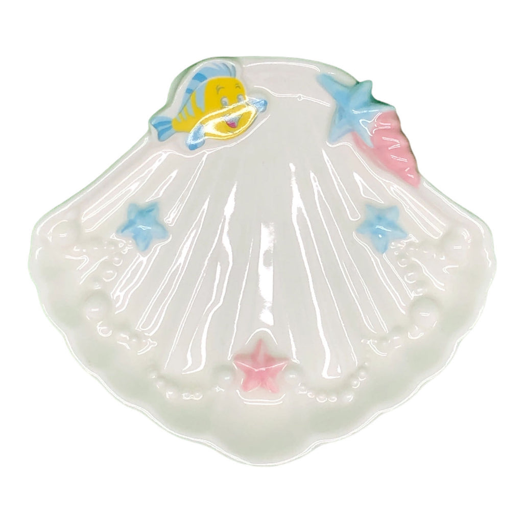 Glossy seashell-shaped jewelry plate with a cheerful yellow-striped fish design, accompanied by pastel-colored starfish accents.
