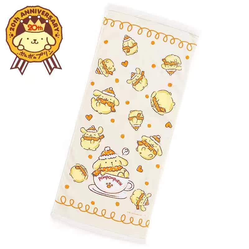Pompompurin long towel with multiple illustrations of Pompompurin in a teacup and wearing a knitted cap, celebrating 20th anniversary, on a white and orange background.