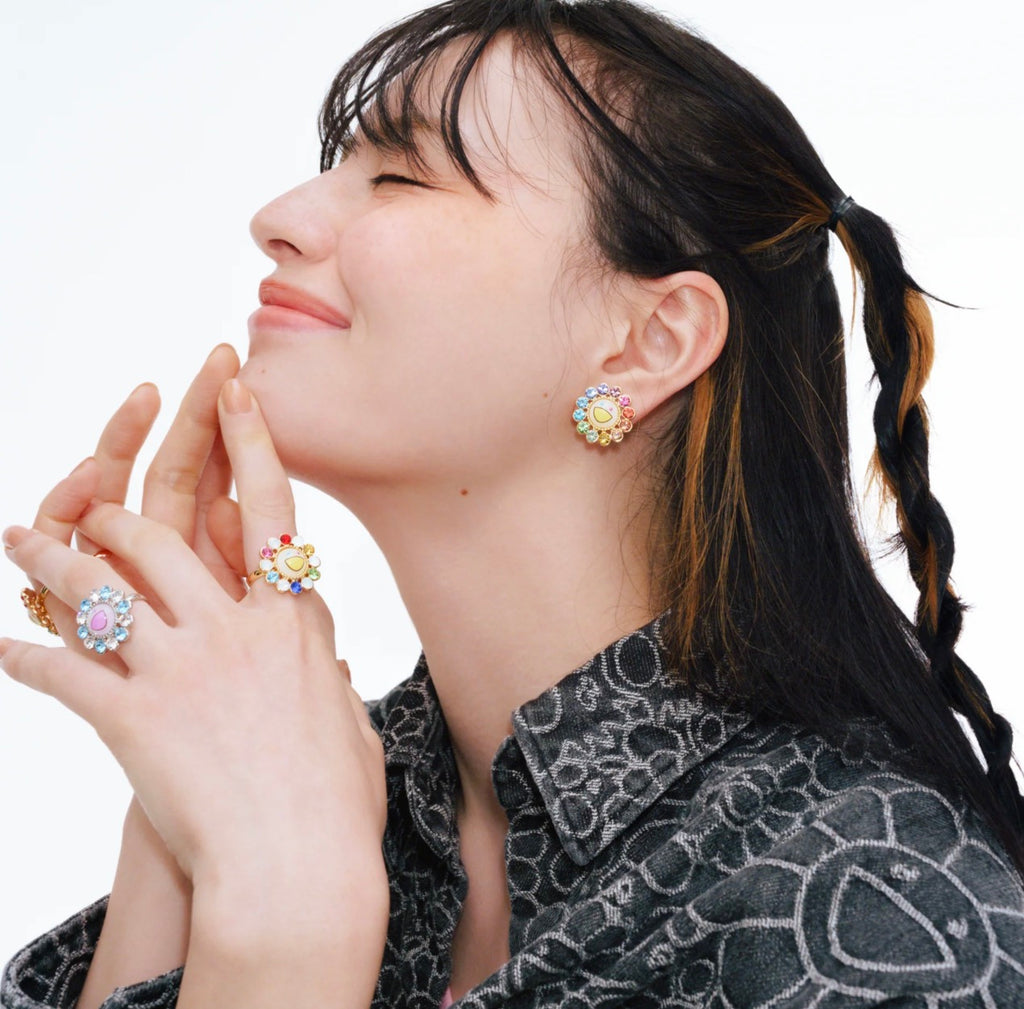 Model wearing Takashi Murakami Multi-Color Flower Earrings, showcasing the vibrant and playful design