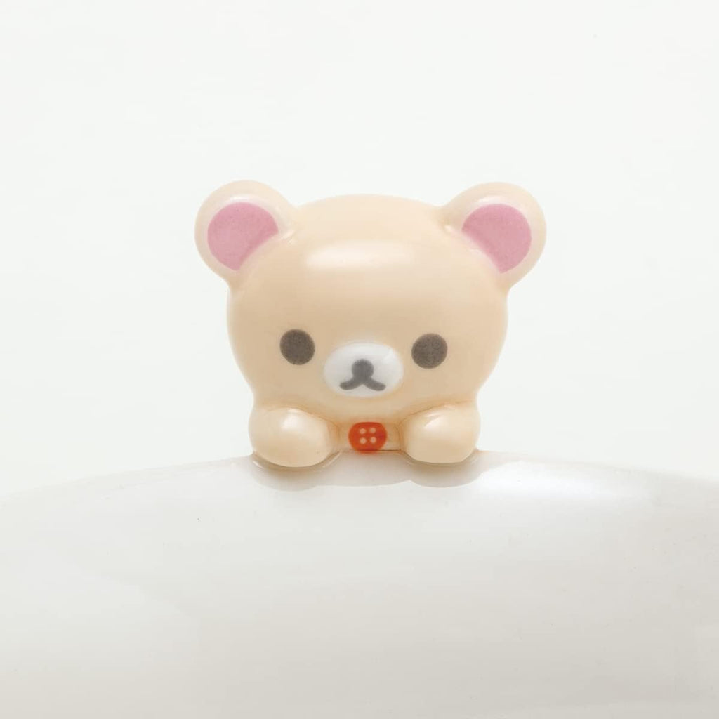 Close-up of the Korilakkuma figure attached to the rim of the San-X Chawan Bowl, with its iconic pink ears and red button.
