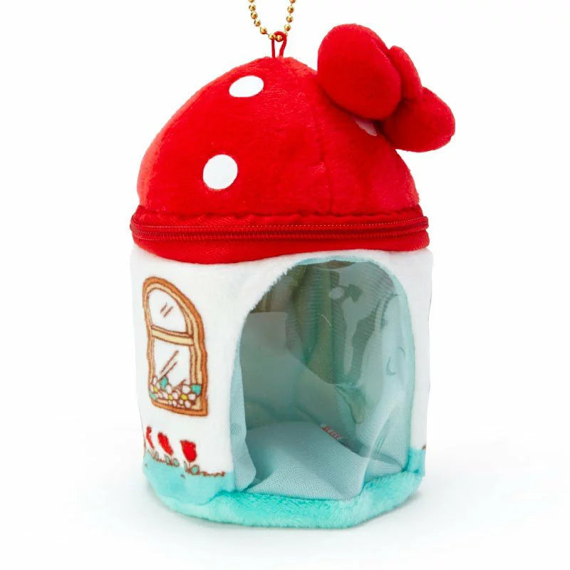 Plush Hello Kitty charm in a mushroom house design, with intricate window and door embroidery.
