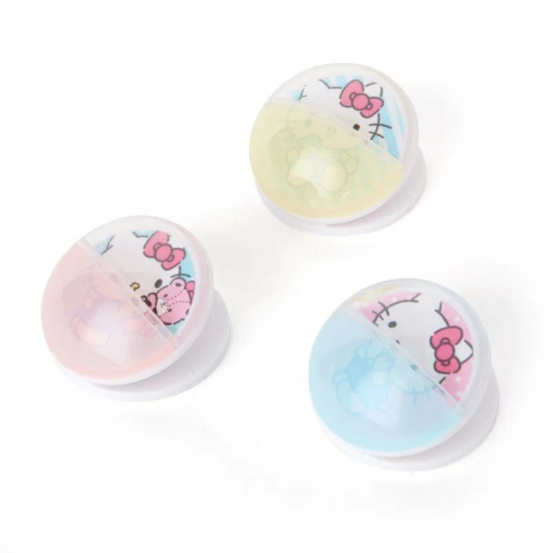 Three pastel-colored shell-shaped clips with Hello Kitty and friends illustrations.