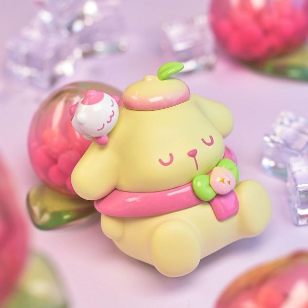 Sanrio's Pompompurin character from the Vitality Peach Paradise Blind Box series, resting on a peach-colored cushion.