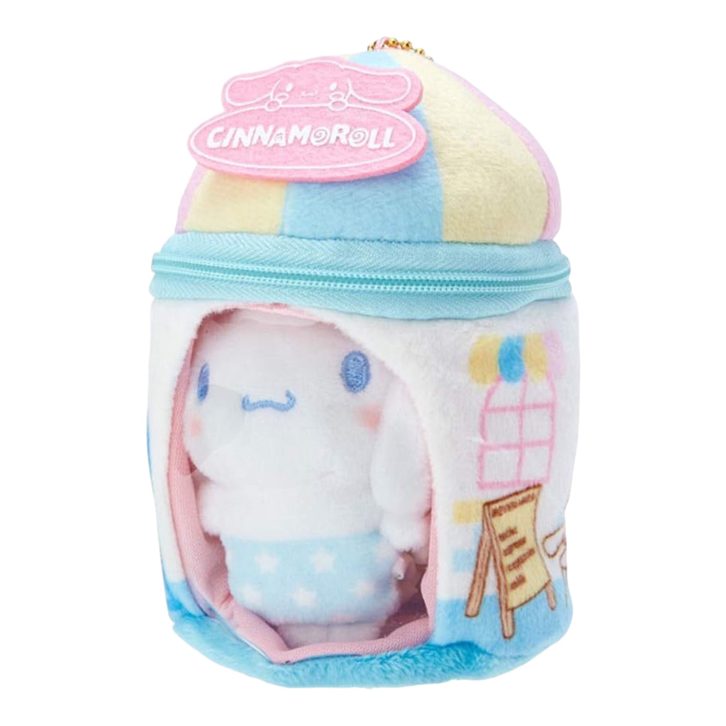 Cinnamoroll plush charm unzipped to reveal a mini plush inside, with the character's name embroidered on the pink and blue roof.