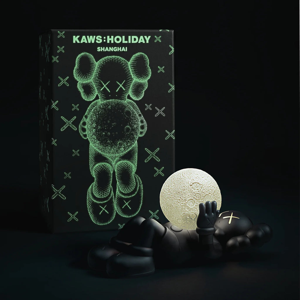 KAWS SHANGHAI Black Figure displayed with its glow-in-the-dark box.