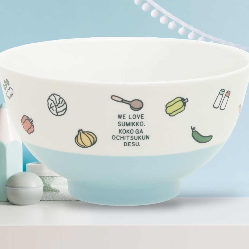 Side view of San-X Sumikkogurashi blue ceramic rice bowl, highlighting playful character quotes and doodles of food items around the bowl.