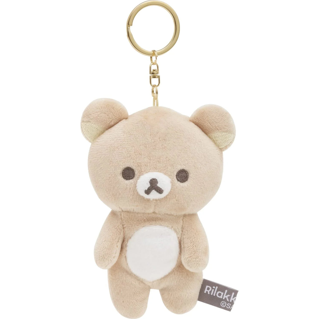 Soft, plush San-X Rilakkuma keyring in a light brown color with white belly and small brown nose, attached to a gold keyring.