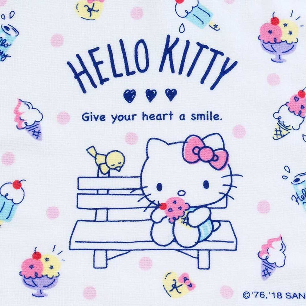 Sanrio Hello Kitty 'Give Me a Smile' facial towel – white towel with Hello Kitty's face and the words 'Give Me a Smile' printed in blue showcasing Hello Kitty is having ice cream on the bench