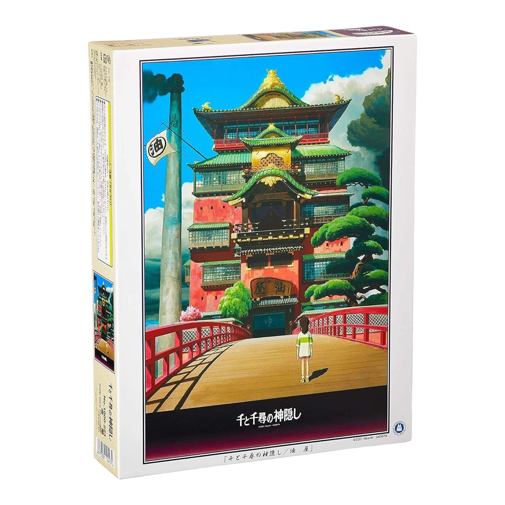 Studio Ghibli Spirited Away 1000-piece jigsaw puzzle box with a vivid depiction of the magical Aburaya Bathhouse, inviting puzzle solvers into Chihiro's enchanting world.