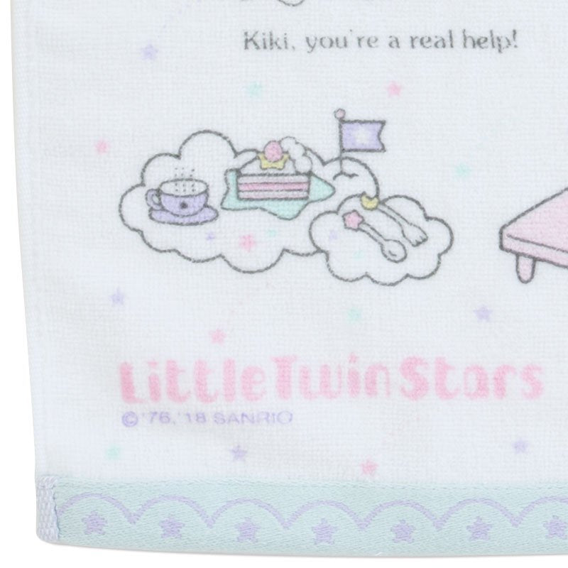 Detailed corner of Little Twin Stars towel with 'My secret ingredient makes the best dough' text and cake illustrations.
