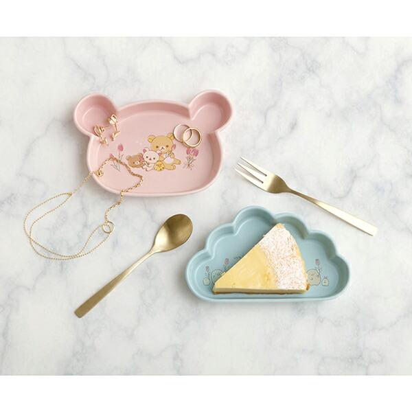 Assortment of San-X tableware including the pink Rilakkuma plate, with matching cups and bowls in soft pastel tones.