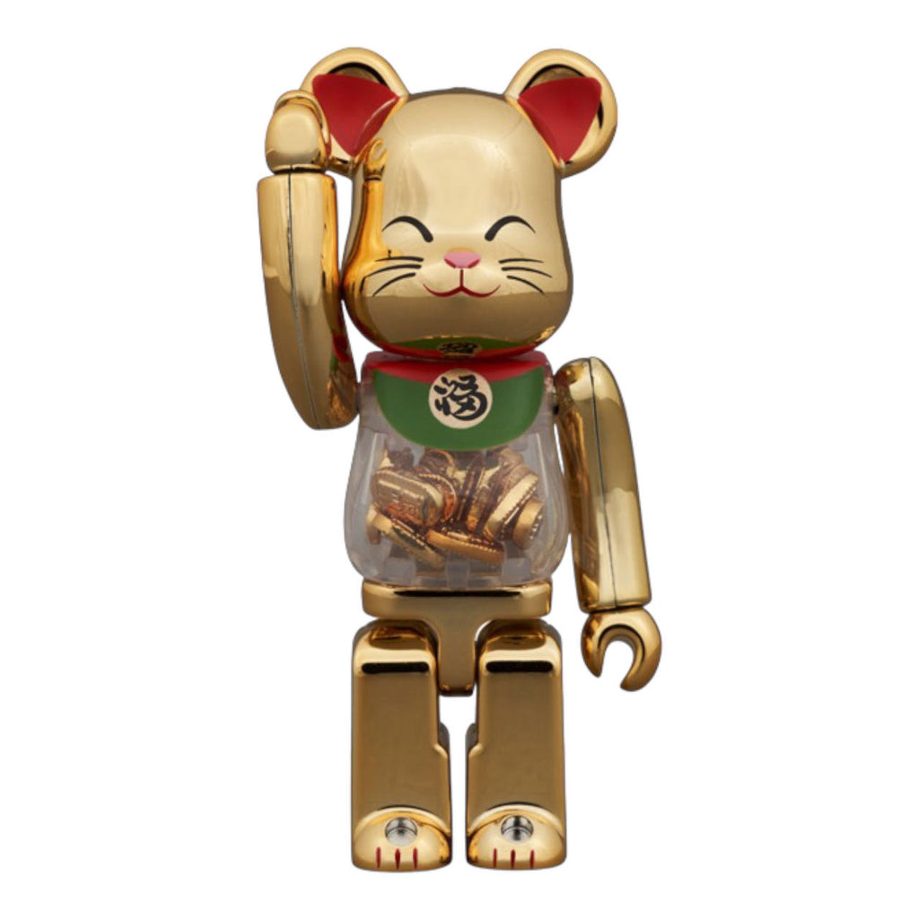 Close-up of the Bearbrick 100% Maneki-Neko Gold figurine with intricate details, including the character's beaming smile and beckoning paw.