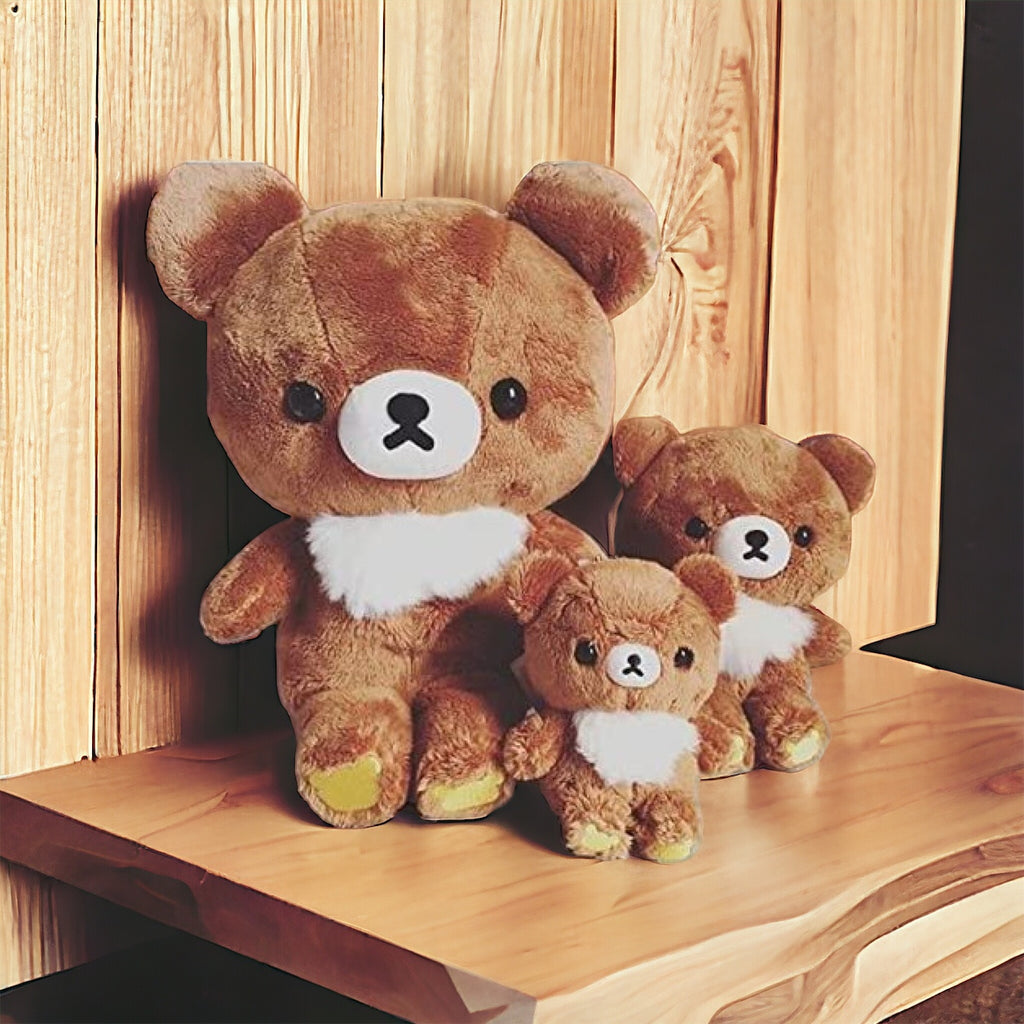 San-X Chairoikoguma M Size Plushie displayed on a shelf alongside smaller versions, creating a family set of bear plushies.