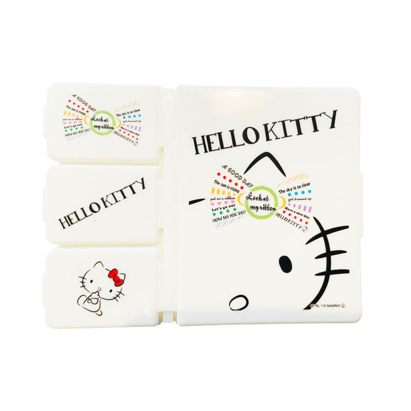 Multi-compartment Hello Kitty pill case with a cute bow design for everyday convenience.