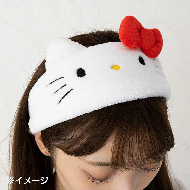 a girl wearing the sanrio hello kitty head band with classic red bow