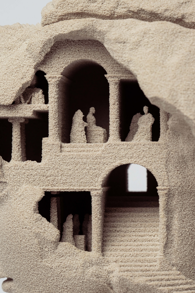 Interior architectural detail inside the sculpture with columns and figures