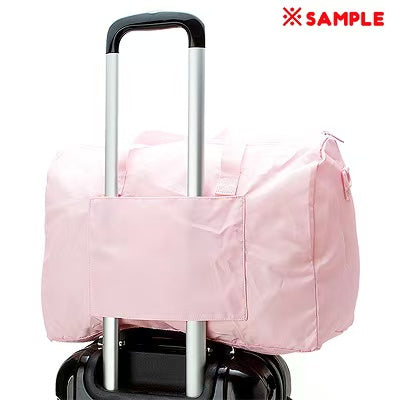My Melody travel bag mounted on suitcase handle via back sleeve strap.