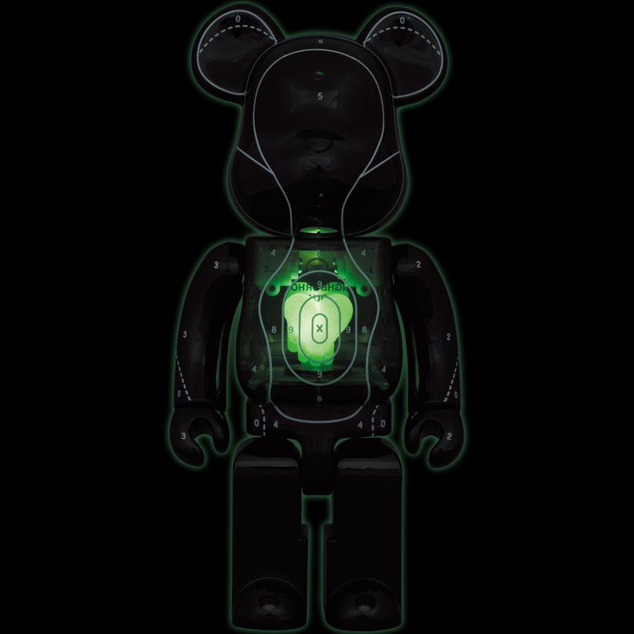 Glowing Bearbrick figurine in dark surroundings, featuring neon green digital-themed designs and circuits, with a prominent green love heart  in the center of its body.