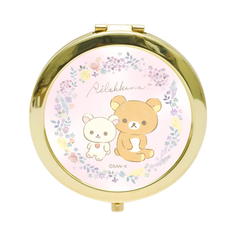 Front view of the Rilakkuma compact mirror featuring a floral design and gold-tone frame, measuring 3.0 x 2.8 x 0.4 inches.