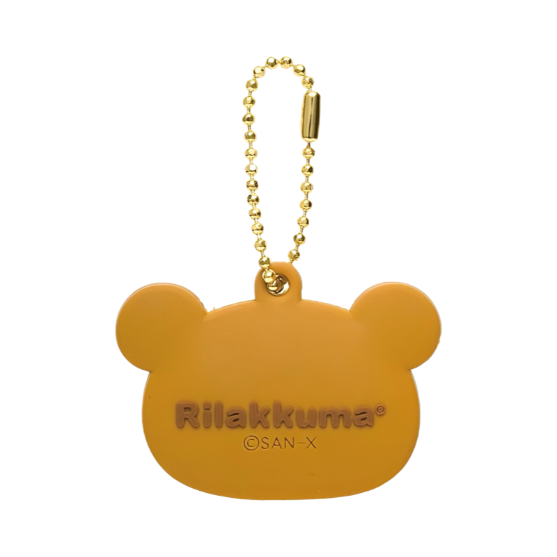 Back view of the Rilakkuma key cover with official San-X branding and gold chain.
