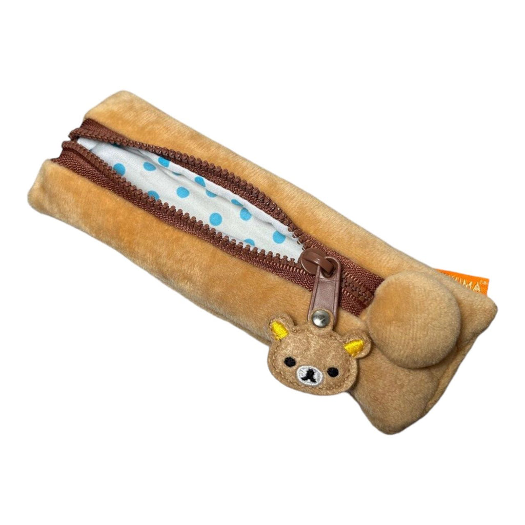 Rilakkuma plush pencil case with polka dot lining, displayed in open view.