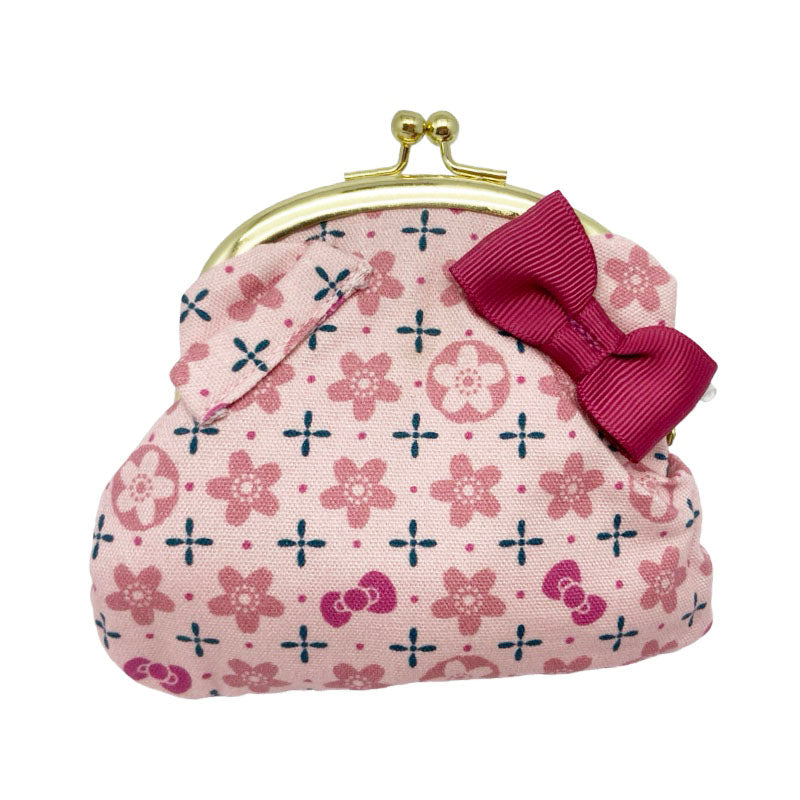 Front view of a Sanrio Hello Kitty Japanese-style coin purse in pink, featuring a sakura flower pattern and a bow, with a gold kiss-lock closure.