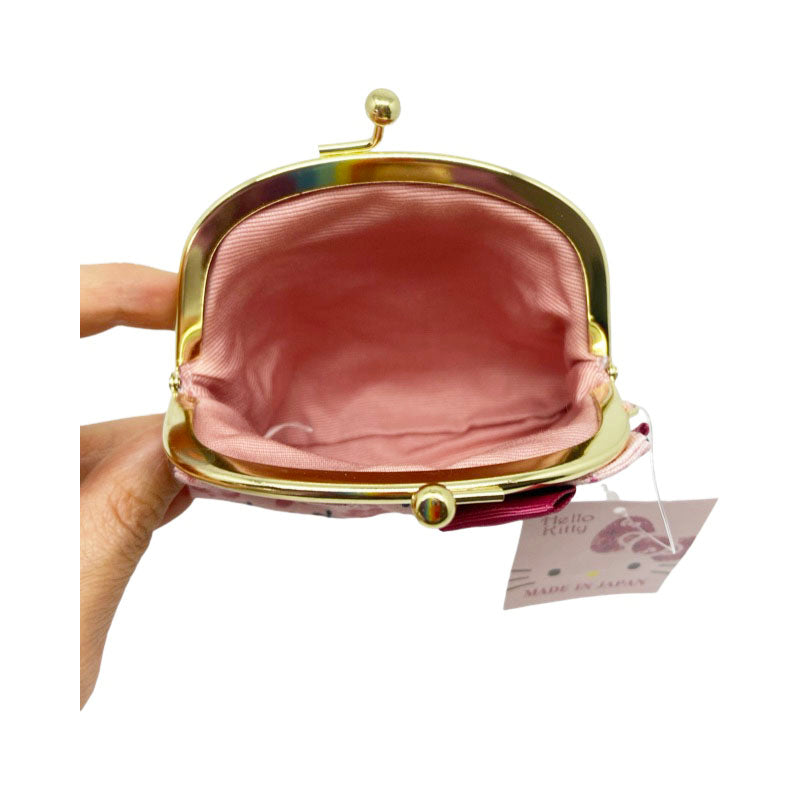 Inside view of a Sanrio Hello Kitty Japanese-style coin purse in pink, showing the spacious interior and gold kiss-lock closure.