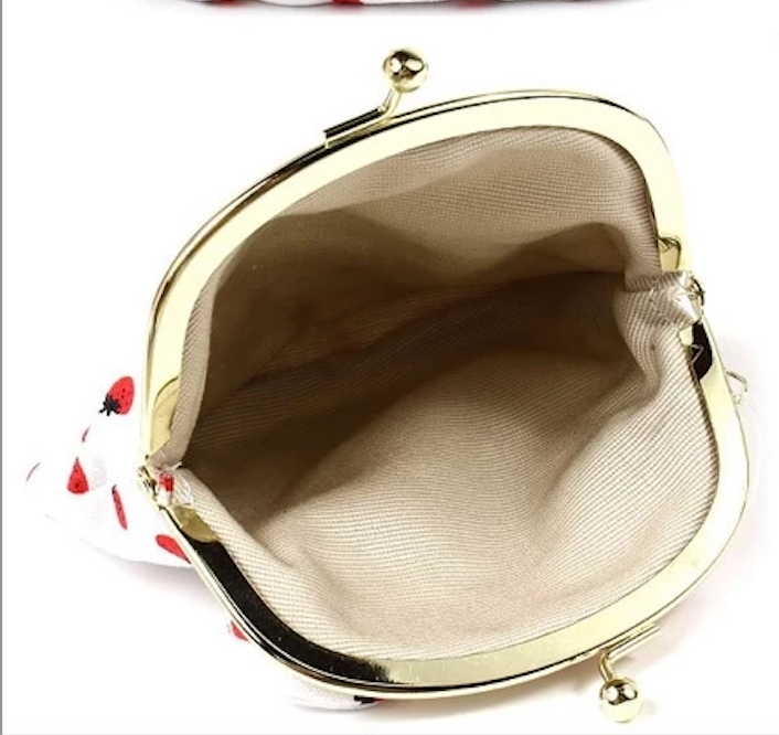 Inside view of Sanrio Hello Kitty coin purse, showing beige lining and spacious interior