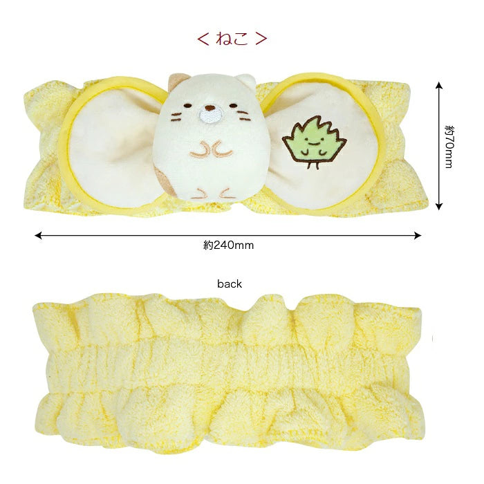 Plush Sumikkogurashi Neko hair band with a soft yellow fabric, featuring a cute embroidered cat and leaf design.