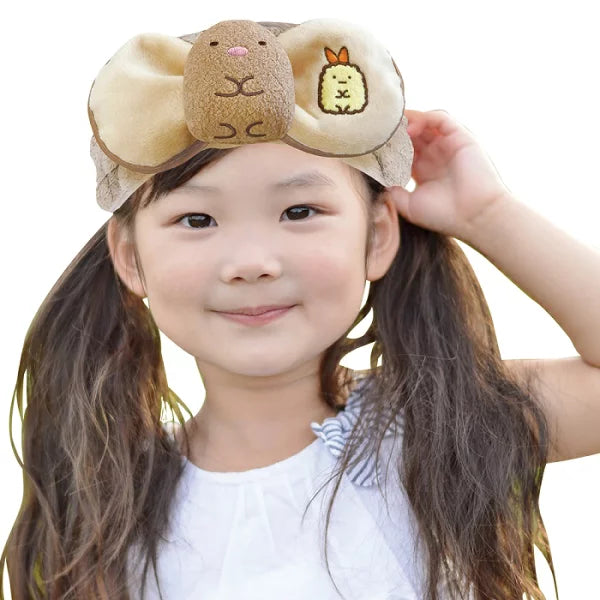 Young girl wearing a San-X Sumikkogurashi Tonkatsu plush hairband, designed for comfort and cuteness during skincare or styling routines.