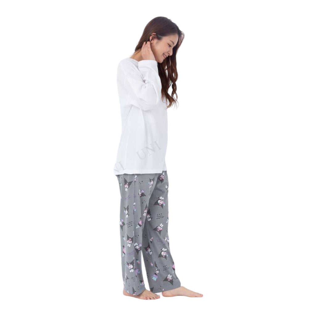 Three-quarter view of a woman in a Kuromi Pajama Set, featuring a minimalistic character design on the white top and playful prints on gray pants.