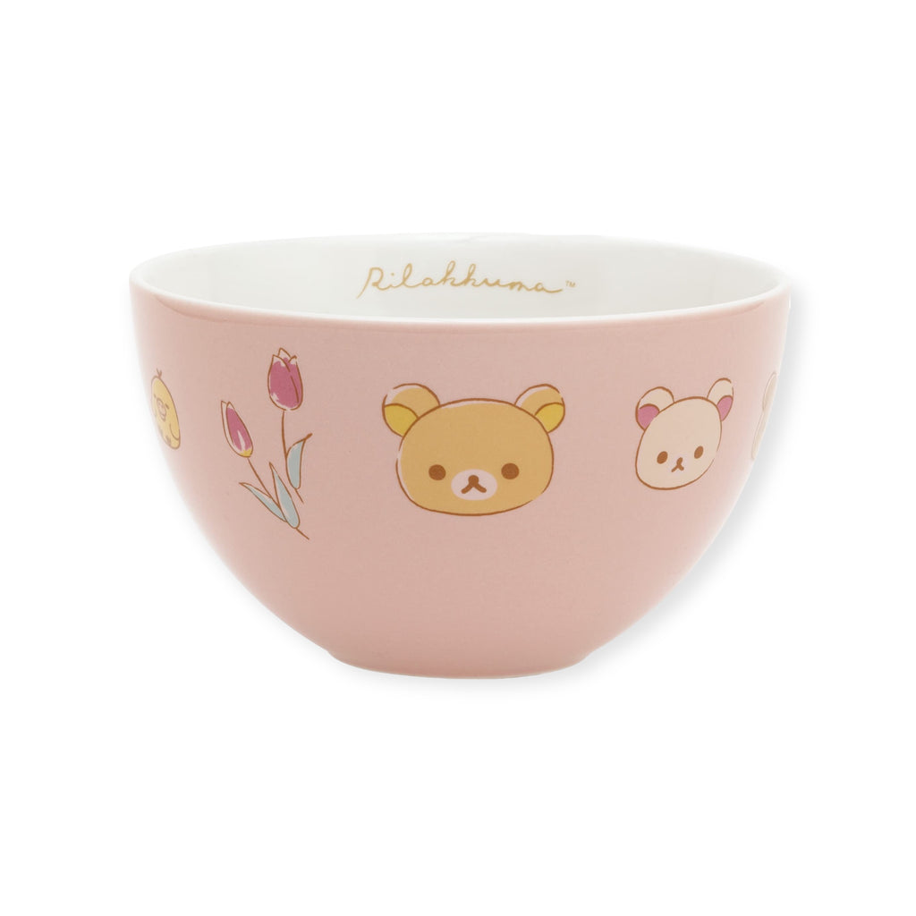 Pastel pink San-X Rilakkuma ceramic bowl with cute bear and tulip illustrations on the side, 'Rilakkuma' written on the inner rim.