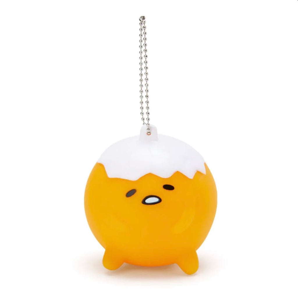 Sanrio Gudetama Whistle Mascot Holder with a white eggshell on top and a sleepy Gudetama face, attached to a silver chain.