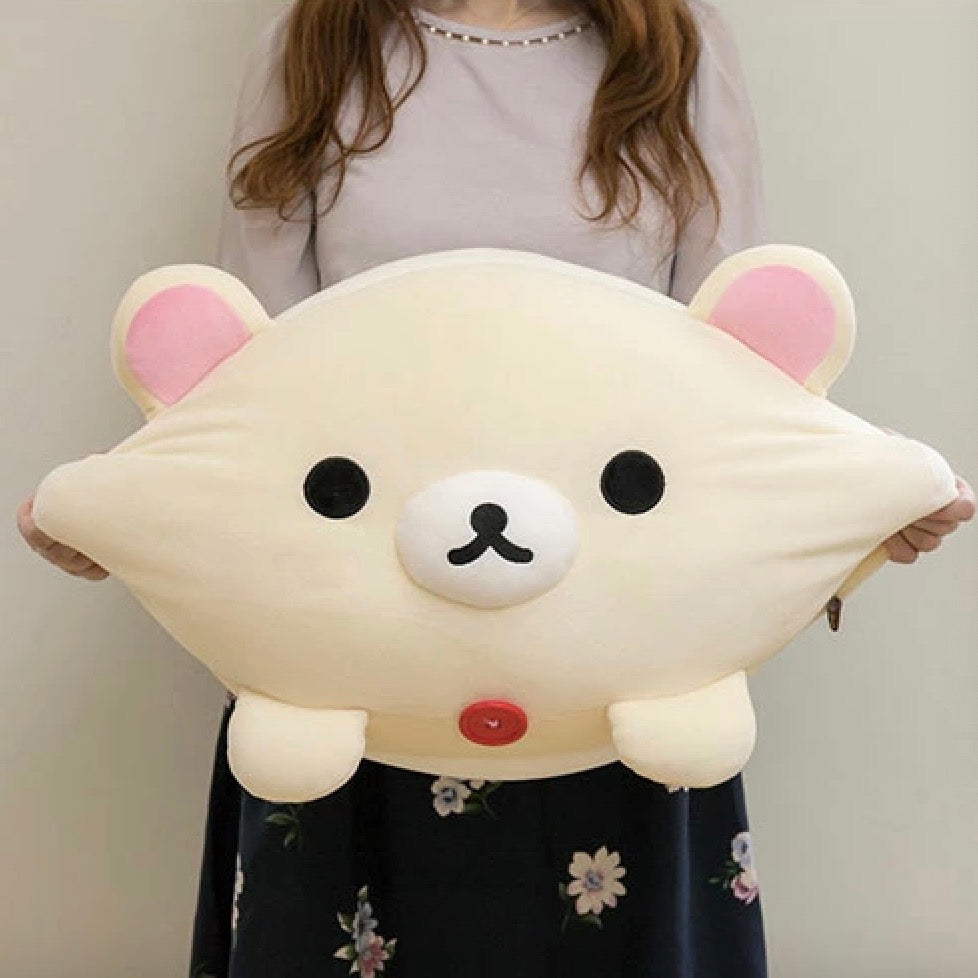 Girl holding a large Korilakkuma Mochi Cushion M Size, showcasing the plush's cuddly size and adorable design.