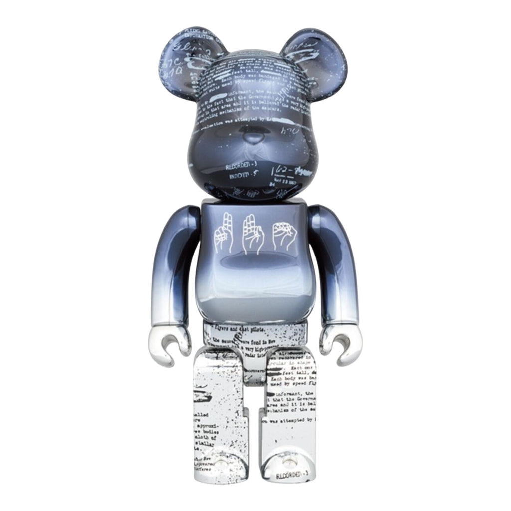 Close-up view of Bearbrick UFO 2nd version with intricate black and white script designs.