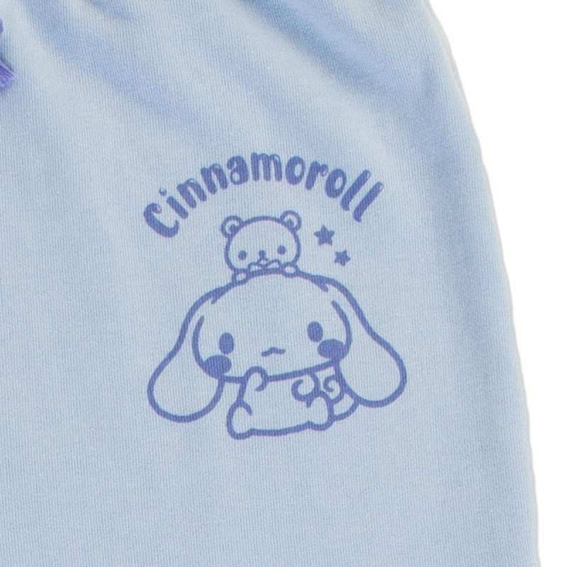 Zoomed-in detail of Cinnamoroll's face on the light blue pajama pants, with the name 'Cinnamoroll' printed above