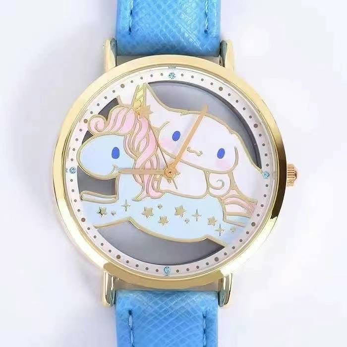 Close-up of Sanrio Cinnamoroll watch face showing a detailed unicorn graphic, golden hands, and star embellishments