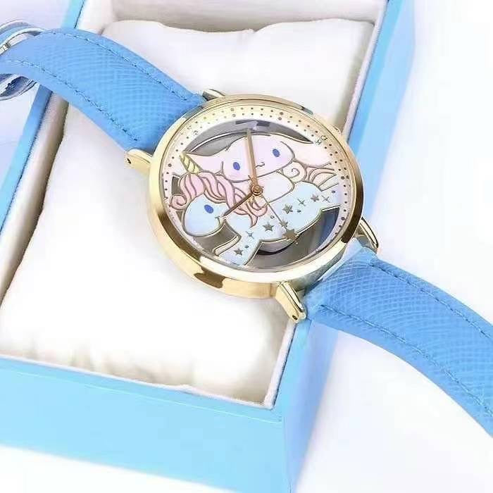 Top view of a Sanrio Cinnamoroll watch in an open box, highlighting the unicorn on the dial and the blue leather strap