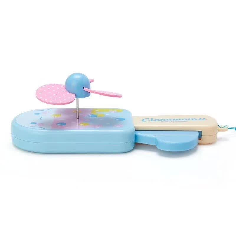 Sanrio Cinnamoroll handheld fan in blue, lying flat with the fan blades and cute character embellishments visible