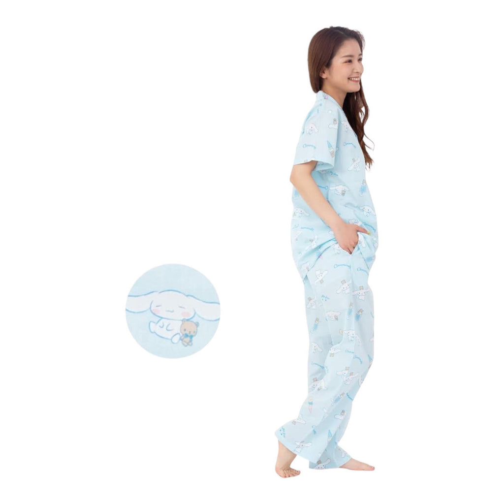 Side view of a woman in a Cinnamoroll pajama set, hands on hips, featuring whimsical character patterns on light blue fabric