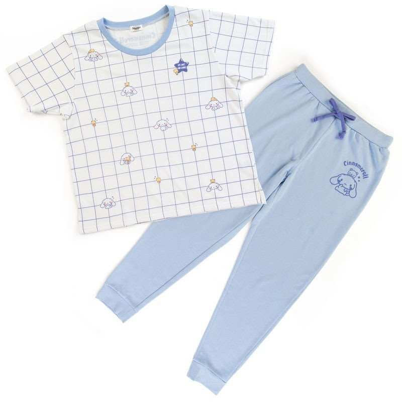 Complete Sanrio Cinnamoroll Pyjama set laid out, with a white grid-patterned top featuring Cinnamoroll graphics and solid light blue pants
