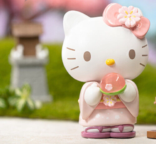 Hello Kitty figure holding a peach blossom wagashi, part of the Sanrio Blossom & Wagashi Series Blind Box