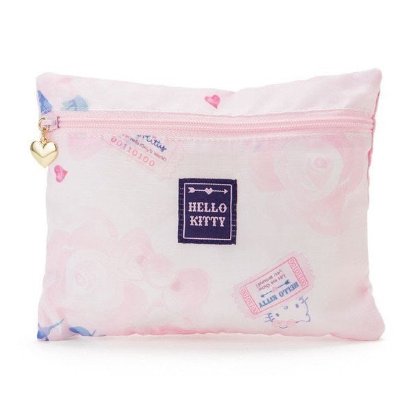 Matching Hello Kitty travel pouch in pink with stamps and heart prints, embellished with a gold heart charm