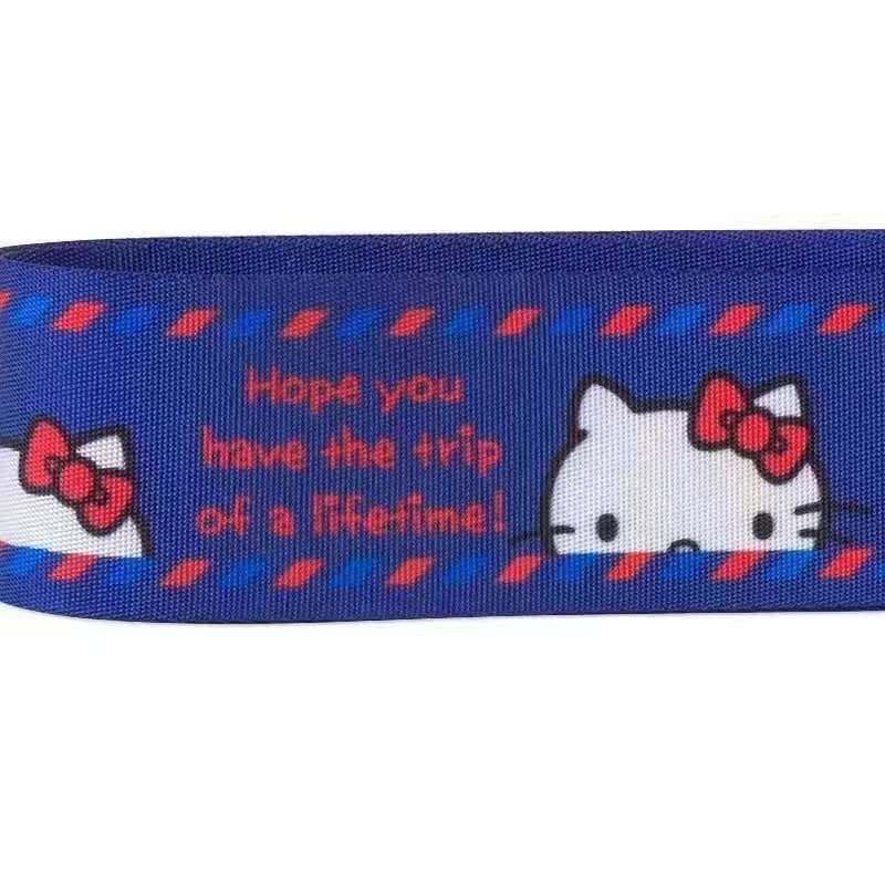 Close-up of the Sanrio Hello Kitty luggage strap with the phrase "Hope you have the trip of a lifetime!" next to a Hello Kitty graphic.