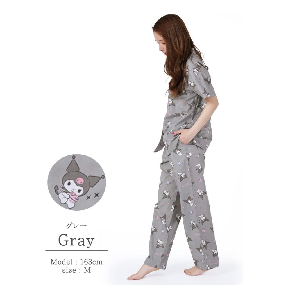 Side profile of a woman wearing a gray Kuromi pajama set, featuring playful character prints on the shirt and matching pants