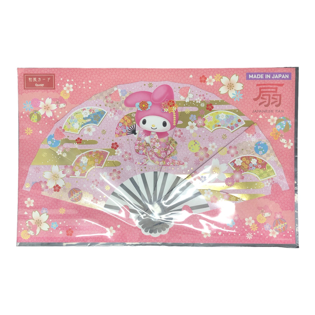 Sanrio My Melody Christmas greeting card displaying the character in a decorative kimono with a Japanese fan backdrop, capturing the essence of the holidays with a kawaii twist.